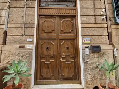 a wooden door on the side of a building at CapoMassimo in Palermo