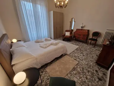 a bedroom with a bed and a dresser and chairs at CapoMassimo in Palermo