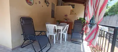 a patio with a table and chairs on a balcony at Villa Alba in Palermo