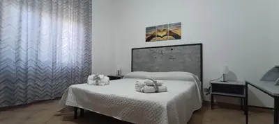 a bedroom with a bed with towels on it at Villa Alba in Palermo