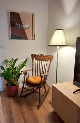 a room with a rocking chair and a lamp at MAGGESE Dimora di Charme in Palermo