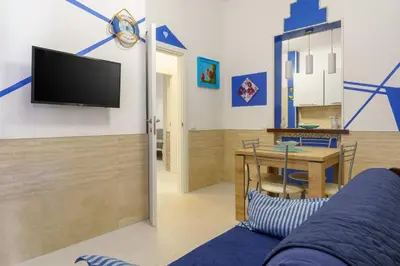 a living room with a tv and a table at Ruci ruci in Mondello