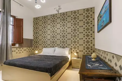 a small bedroom with a bed and a table at Ruci ruci in Mondello