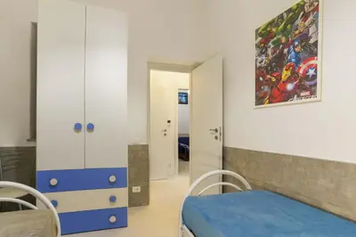 a room with a bed and a painting on the wall at Ruci ruci in Mondello