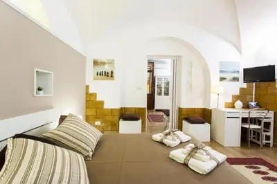 a bedroom with a bed with two towels on it at Palermo Central Holiday in Palermo