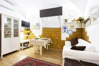 a living room with a white couch and a table at Palermo Central Holiday in Palermo