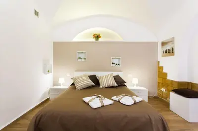 a bedroom with a large bed with two towels on it at Palermo Central Holiday in Palermo