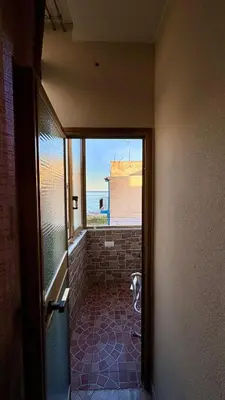 a door to a room with a dog standing in the doorway at FronteMare12 in Palermo
