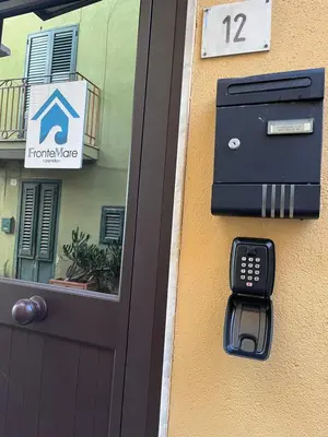 a door with a cell phone next to a house at FronteMare12 in Palermo