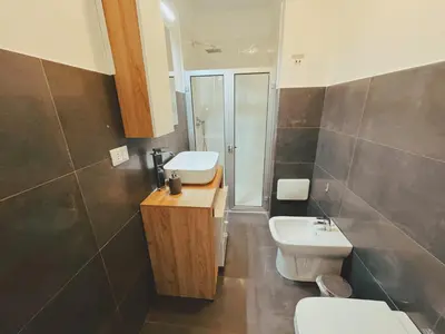 a bathroom with a toilet and a sink at Candalù - Palermo Suite in Palermo