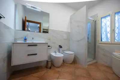 a bathroom with a sink and a toilet and a shower at Gulliver's Nest in Castellammare del Golfo