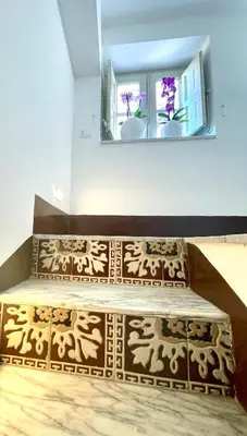 a bed in a room with a window and a window sill at Bella Kalsa in Palermo