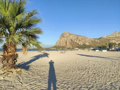 a shadow of a person standing on a beach at Katia Home - San Vito lo Capo in San Vito lo Capo