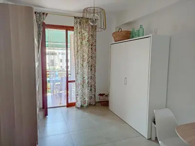 a living room with a white cabinet and a window at Katia Home - San Vito lo Capo in San Vito lo Capo