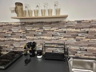 a kitchen with a counter top with a brick wall at La Casuzza 2 in piazzetta in Palermo