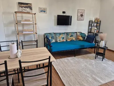 a living room with a blue couch and a table at La Casuzza 2 in piazzetta in Palermo