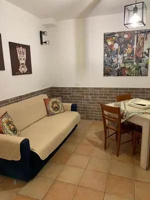 a living room with a couch and a table at Vucciria Holiday - Centro storico - via Emanuele in Palermo