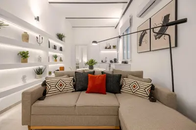 a living room with a couch with colorful pillows at Appartamento Amari 148 in Palermo