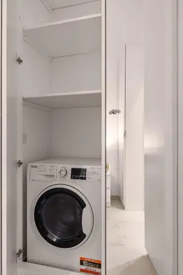 a washer and dryer in a white laundry room at Appartamento Amari 148 in Palermo