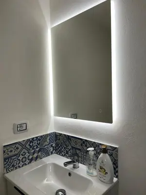 a bathroom with a sink and a mirror at La Maiolica 61 in Terrasini