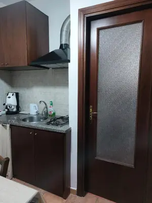 a door in a kitchen with a sink and a counter at Il Rifugio Delle Giuiuzze in Palermo