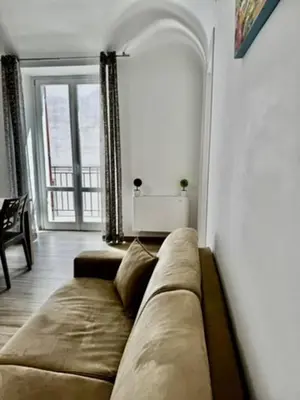a living room with a couch and a large window at Terrasini Center Apartments in Terrasini
