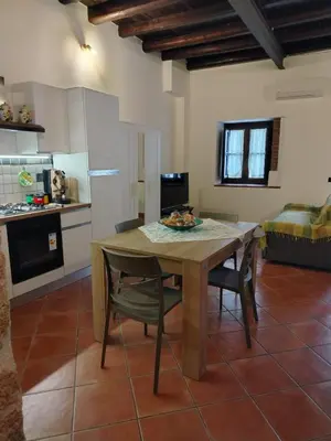 a kitchen and dining room with a table and chairs at Vittorio Cathedral House in Palermo