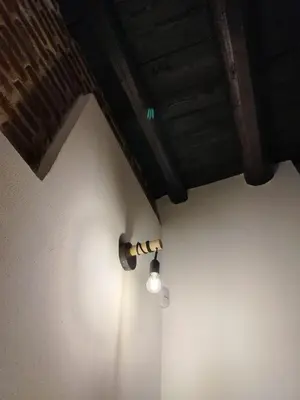a light on the corner of a room with a ceiling at Vittorio Cathedral House in Palermo