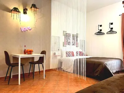 a bedroom with a bed and a table with chairs at Casamori 1-centro storico Palermo in Palermo