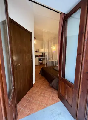 an open door to a room with a bedroom at Casamori 1-centro storico Palermo in Palermo