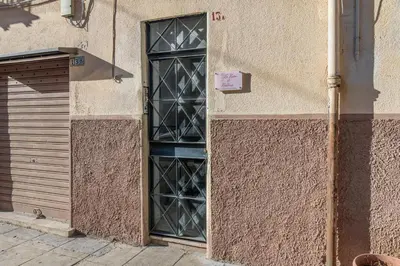 a door to a building with a glass window at GuestHost - La Rosa di Ballarò Palermo Apartment in Palermo