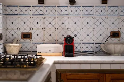 a red appliance sitting on a counter in a kitchen at Principe di Castelnuovo Historical Suites in Palermo