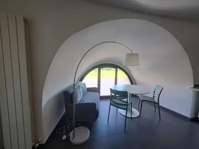 a living room with a table and a couch at La Lunetta - romantic little house in Palermo