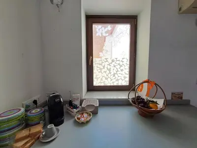 a kitchen with a window and a bowl of food at La Lunetta - romantic little house in Palermo