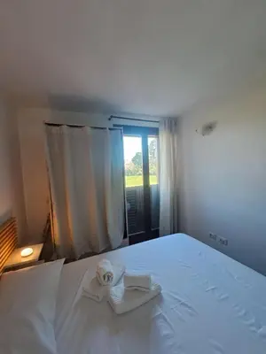 a bedroom with a white bed with towels on it at La Lunetta - romantic little house in Palermo