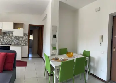 a dining room with a table and green chairs at Molo Sbrijù - Palermo Centro in Palermo