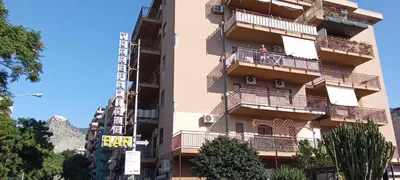 a building with balconies and a bar sign on it at Molo Sbrijù - Palermo Centro in Palermo