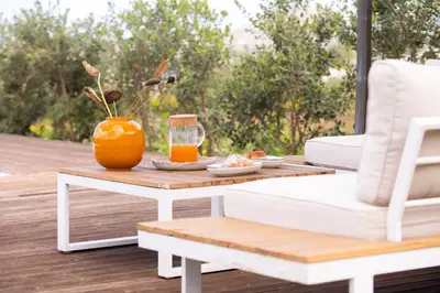 an orange vase sitting on a coffee table on a patio at Villa Manù country house in Castellammare del Golfo