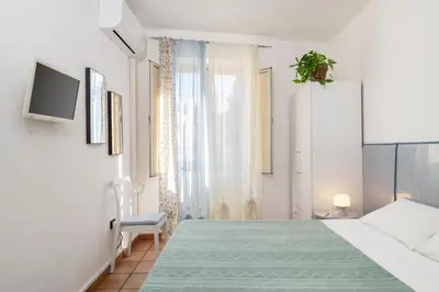 a white bedroom with a bed and a window at Cathedral View Apartment 2 Stanze Matrimoniali con Balcone in Centro in Palermo