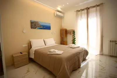 a bedroom with a bed with two towels on it at Front Palermo House in Palermo