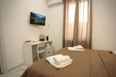 a room with a bed with towels on it at Front Palermo House in Palermo