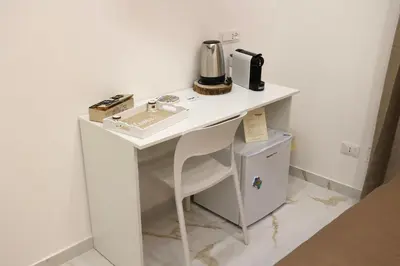 a white desk with a coffee maker on top of it at Front Palermo House in Palermo