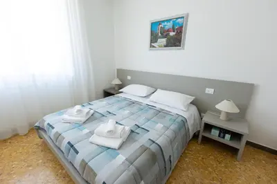 a bedroom with a bed with towels on it at Clar Suite -Grattacielo in Palermo