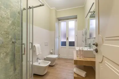 a bathroom with a toilet and a sink and a shower at Alabardieri Apartments by Wonderful Italy in Palermo