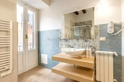 a bathroom with a sink and a mirror at Alabardieri Apartments by Wonderful Italy in Palermo