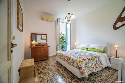 a bedroom with a bed and a mirror and a dresser at Sirene Blu Mondello in Palermo