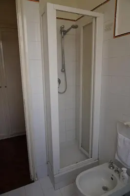 a bathroom with a shower and a toilet and a sink at Sirene Blu Mondello in Palermo