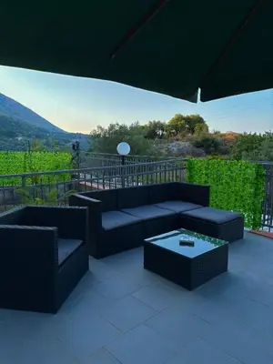 a patio with a couch and a coffee table at Villa Falco in Carini