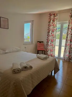 a bedroom with a large bed with towels on it at Villa Falco in Carini