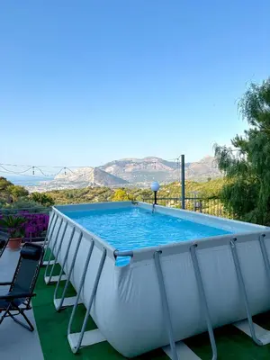 a large swimming pool with chairs around it at Villa Falco in Carini